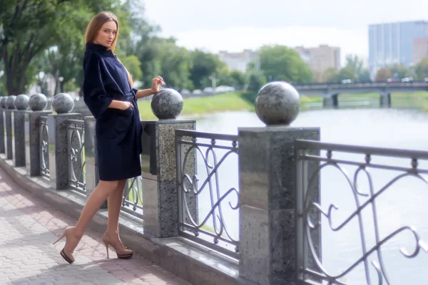 Bella donna dai capelli castani in un cappotto nero — Foto Stock