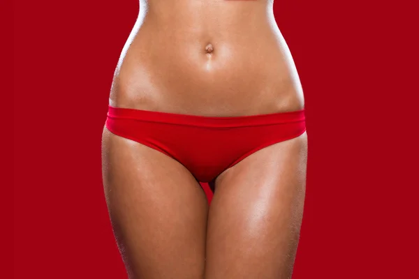 Foto de stock de mujer joven, en forma en traje de baño rojo —  Fotos de Stock