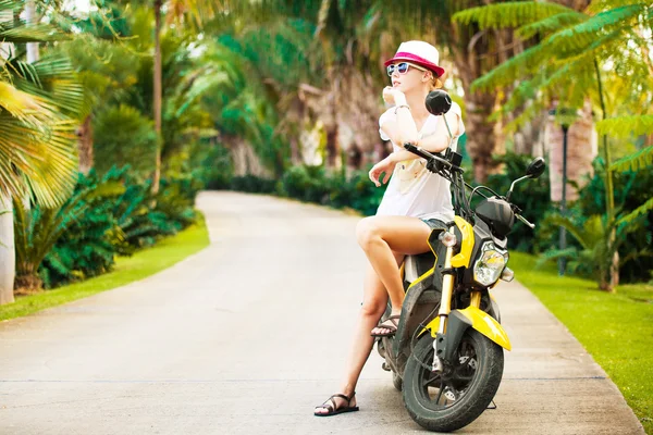 Young beautiful woman sitting on a scooter in thailand park — Stock Photo, Image