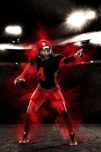 Американський футболіст, спортсмен у червоному шоломі на задньому плані стадіону. Спорт і мотивація шпалери. — стокове фото