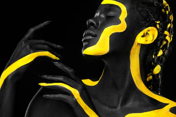 Woman with black body paint. Cheerful young african girl with art  bodypaint. An amazing model with yellow makeup. Closeup face. Stock  Illustration by ©MikeOrlov #375519808