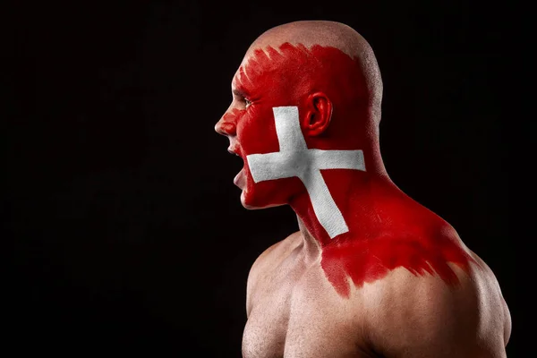 Switzerland fan. Soccer or football athlete with flag bodyart on face. Sport concept with copyspace. — Stock Photo, Image