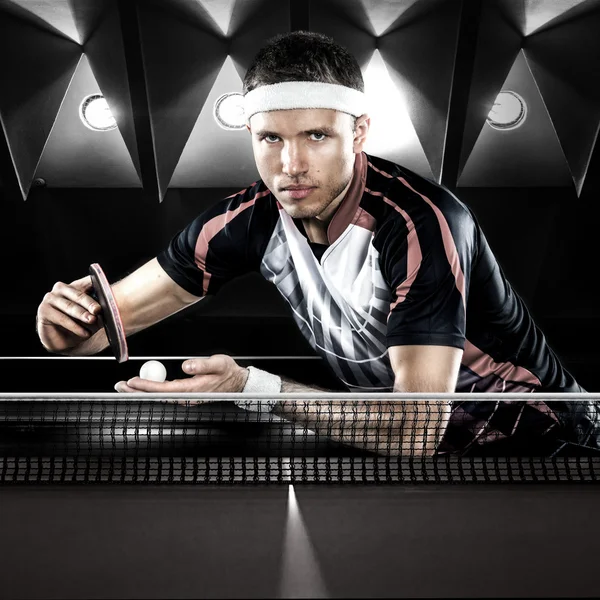 Junger Sportler Tennisspieler im Spiel auf schwarzem Hintergrund — Stockfoto