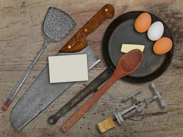 Vintage set for frying eggs over wooden table Stock Image