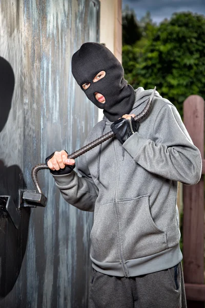 Un ladrón que se abre de una puerta de metal candado — Foto de Stock