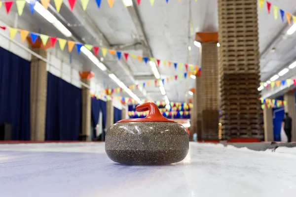 Curling stones on an indoor rink — Stock Photo, Image