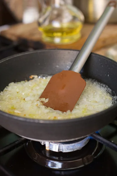 Fried onions in a frying pan — Stock Photo, Image