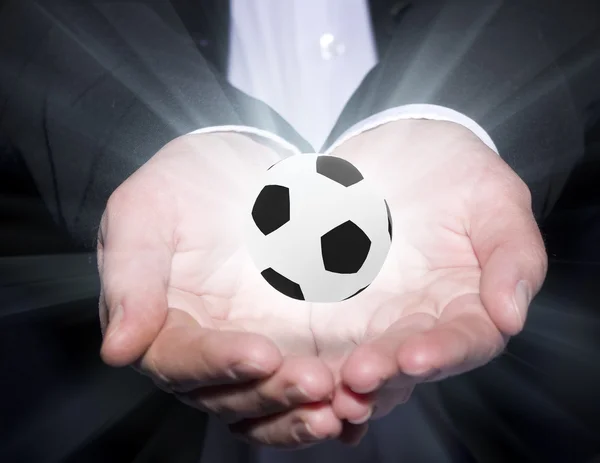 Футбольный менеджер держит мяч — стоковое фото