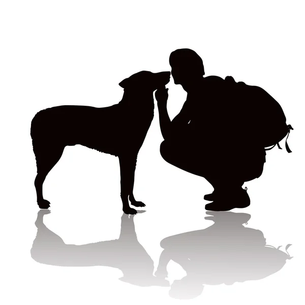 Bir köpek ile genç adam silüeti — Stok fotoğraf