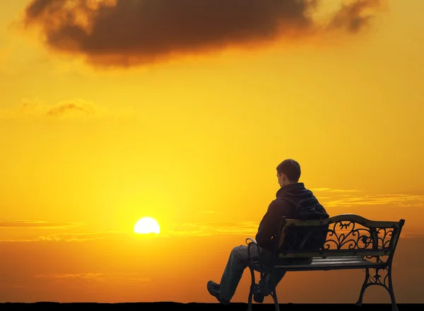 The lonely man sits on a decline Stock Photo