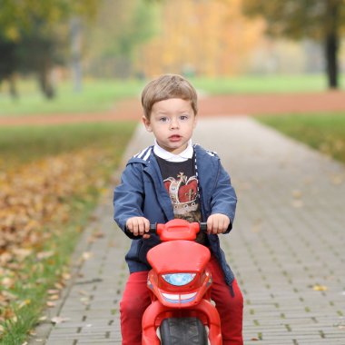 Motosiklet ile yolda sevimli küçük motorcu