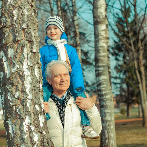 Großvater trägt Enkel auf seinen Schultern — Stockfoto