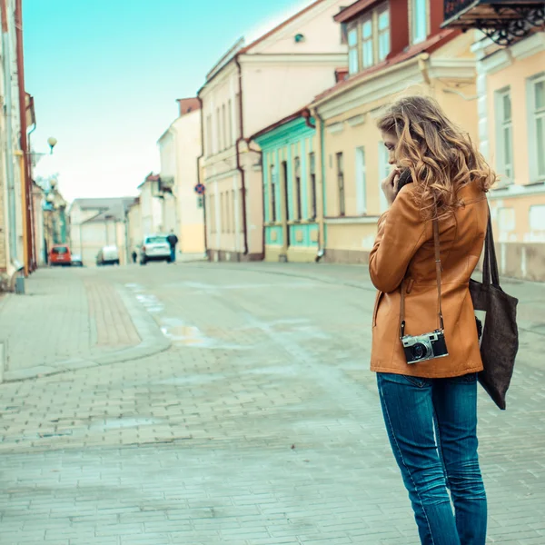 Девушка со старой камерой выходит на улицу — стоковое фото