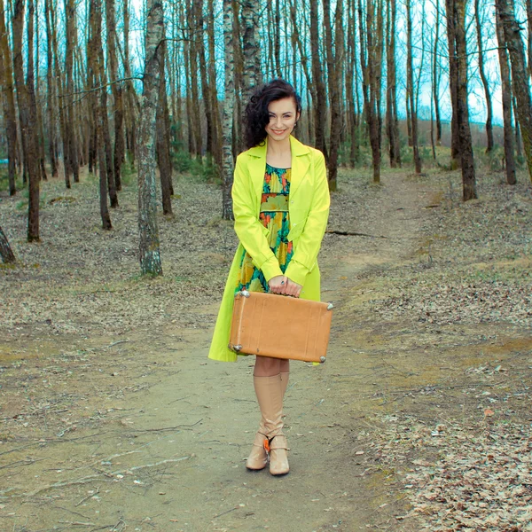 Girl with suitcase at country road — Stock Photo, Image