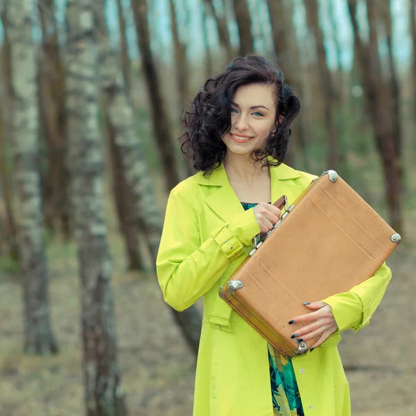 Girl with suitcase at country road — Stock Photo, Image