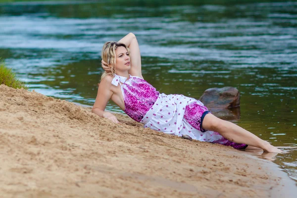 Woman in a long dress on the shore — Stock Photo, Image