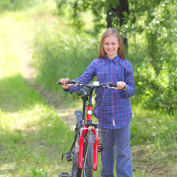 Teenager girl with bicycle in countryside — Stock Photo, Image