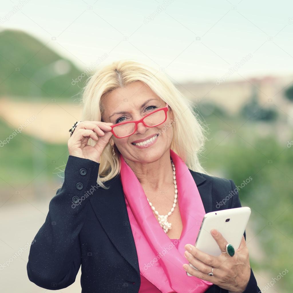 Mature business woman with tablet.