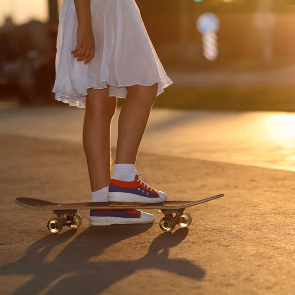 Pernas adolescentes em tênis no skate — Fotografia de Stock