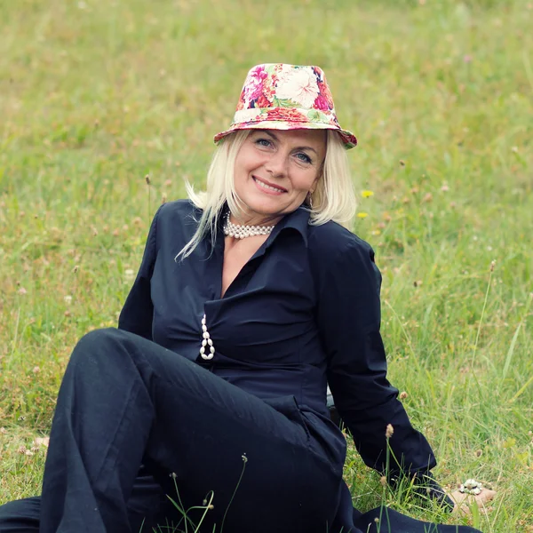 Mature fashionable woman in black suit — Stock Photo, Image