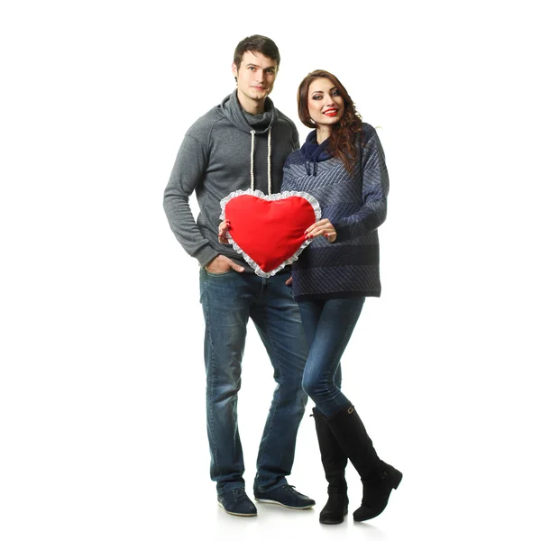 Couple having fun with a pillow in the form of heart — Stock Photo, Image