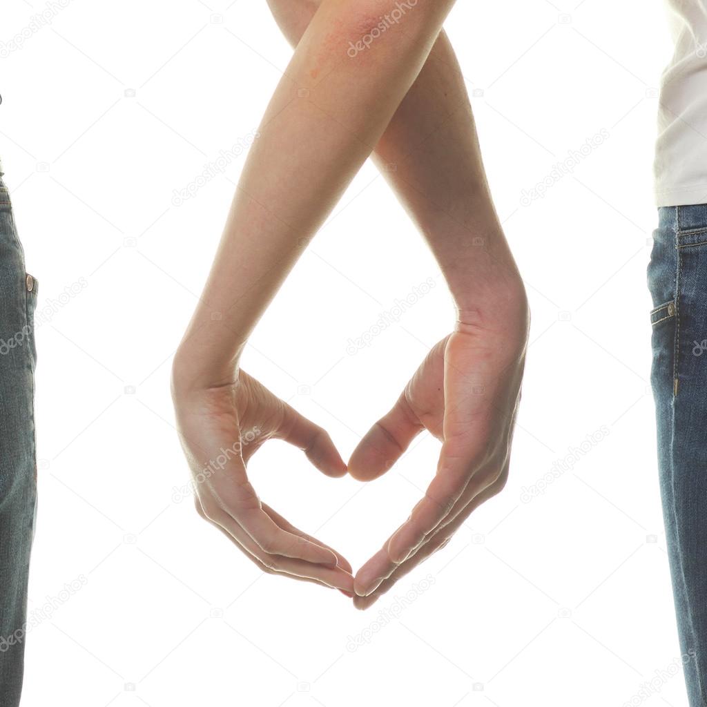 Couple making heart by the fingers.