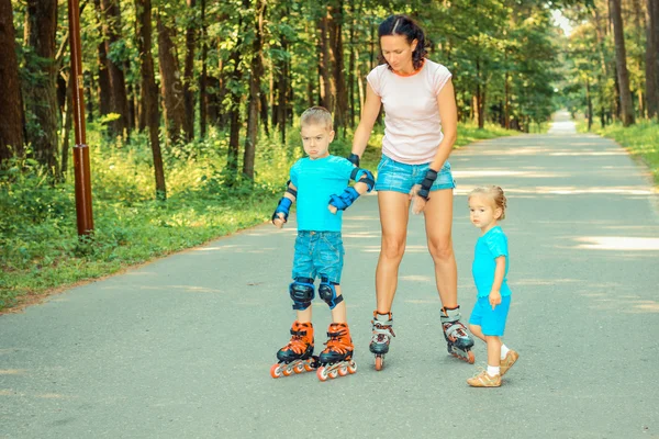 Familjen att ha kul på rullskridskor — Stockfoto