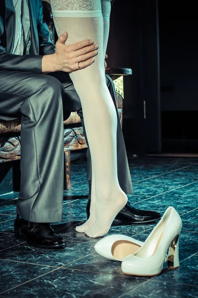 Woman in stocking seducing man — Stock Photo, Image