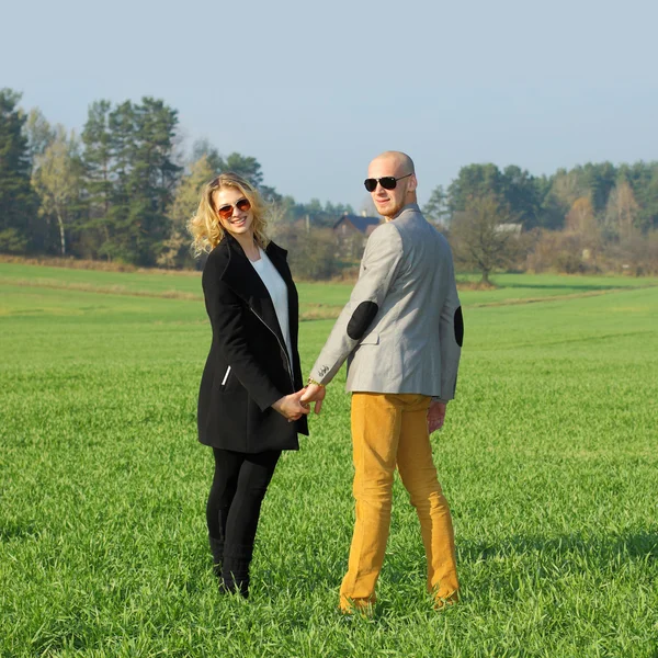 Young beautiful couple in  field — Stock Photo, Image