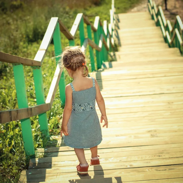 Little girl walking down stairs — Stock Photo, Image