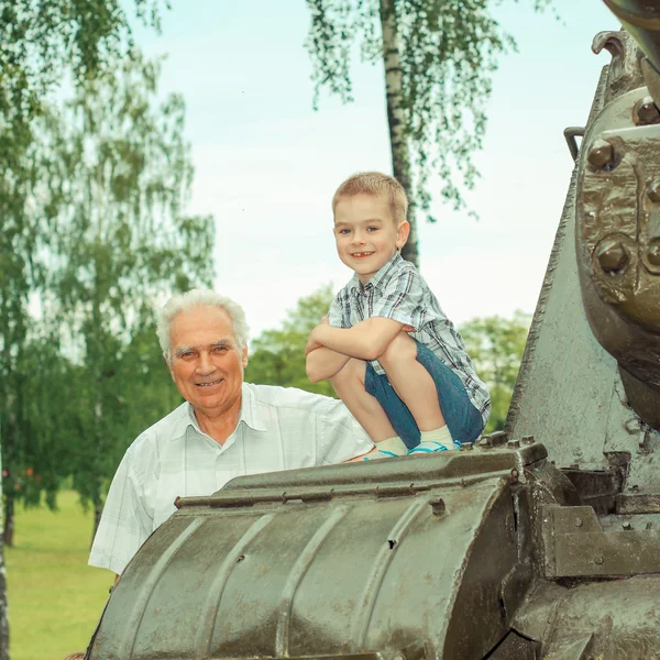 Grandfather and grandson near tank — Stock Photo, Image