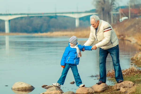 Grandfather and grand crossing river — Stock Photo, Image
