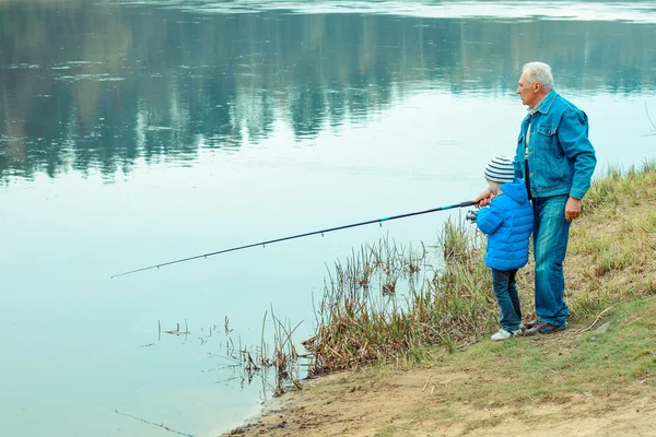 Grandfather and grandson are fishing — Stock Photo, Image