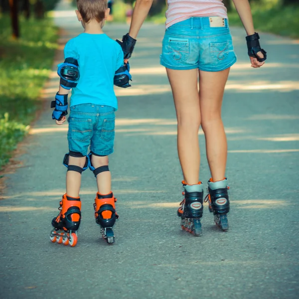 Moeder met kind rolschaatsen — Stockfoto