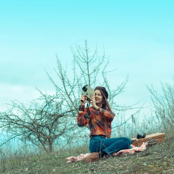 Girl in a plaid shirt  with vintage camera — Stock Photo, Image