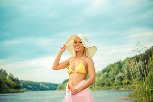 Blond girl in bikini and hat — Stockfoto