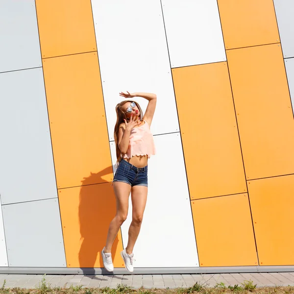 Hipster fashionable girl joyfully jumping — Stock Photo, Image