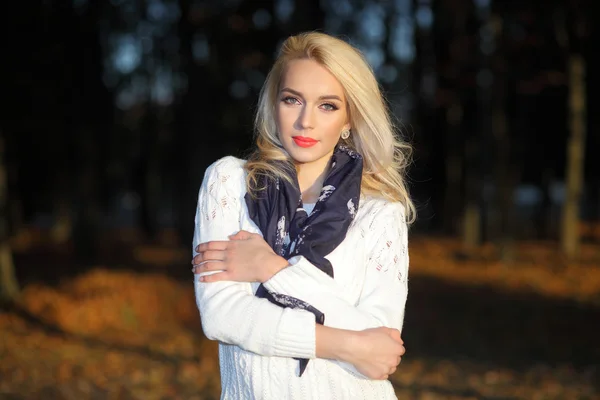 Chica rubia en un suéter blanco en el parque — Foto de Stock