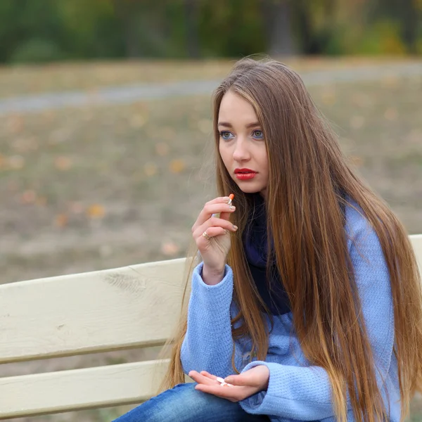 Ragazza triste con pillole all'aperto — Foto Stock