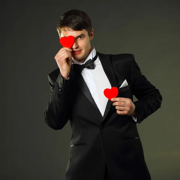 Man in a tuxedo with hearts. — Stok fotoğraf