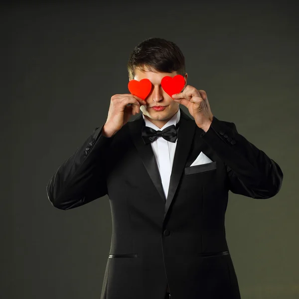 Man in a tuxedo with hearts. — Stock Photo, Image