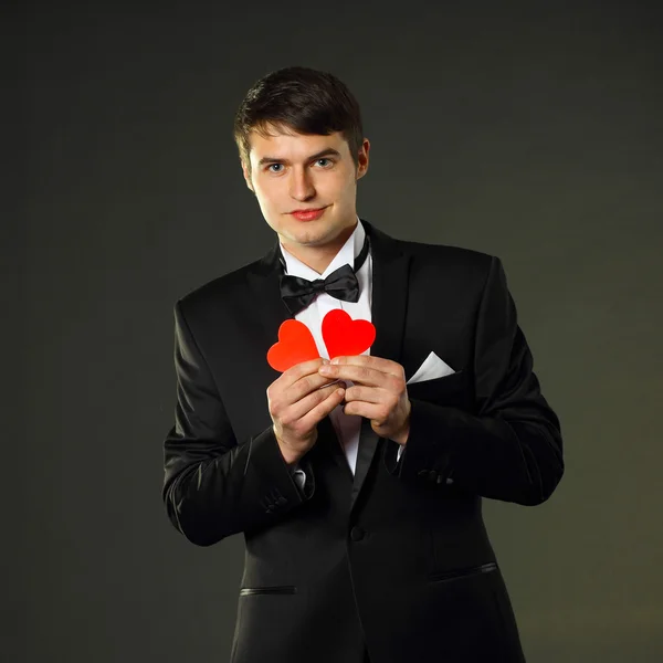 Man in a tuxedo with hearts. — Zdjęcie stockowe