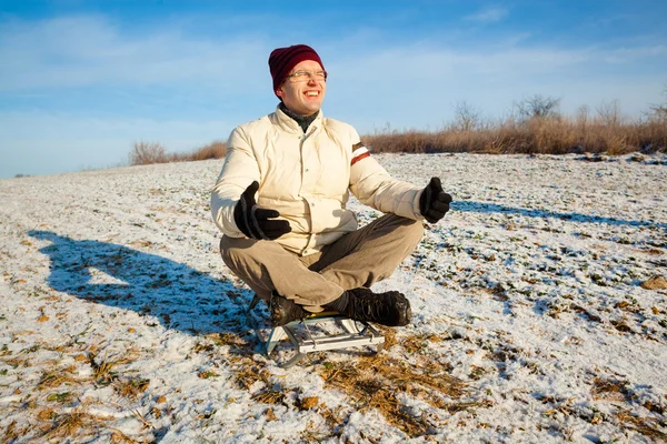 Man meditating on a sledge — Stock Photo, Image