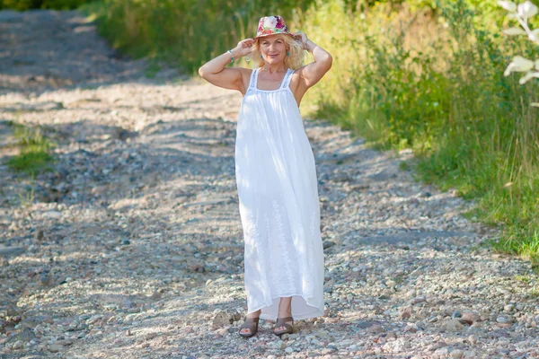 Blonde woman in flower hat — Stock Photo, Image