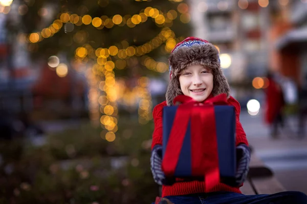 Smiling Boy Holding Christmas Present Enjoying Outdoor Holiday Time Beautiful — Stock Photo, Image