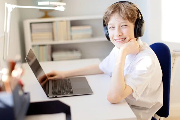 Positive Smiling Boy Online Learning Home Coronavirus Pandemic Using Laptop 스톡 사진