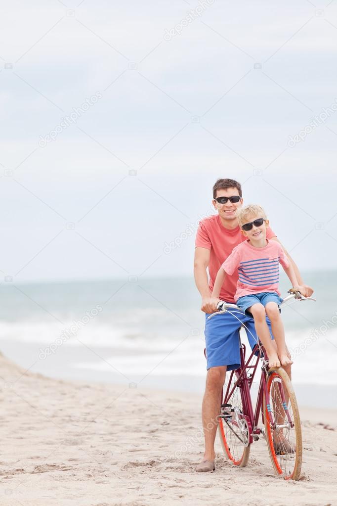 family biking at the beach