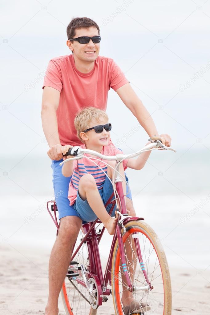 family biking at the beach