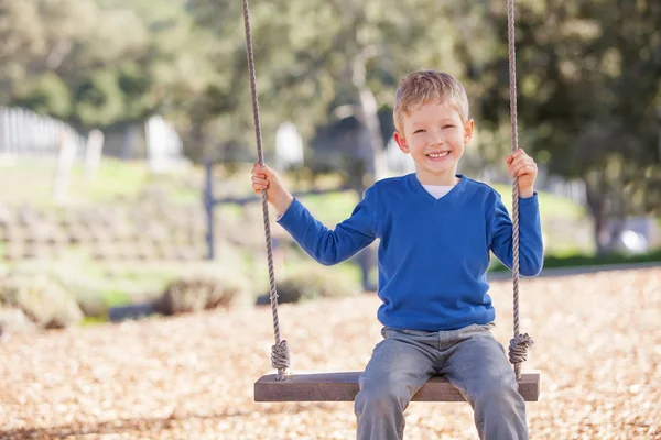 Boy at swings — Stock Photo, Image