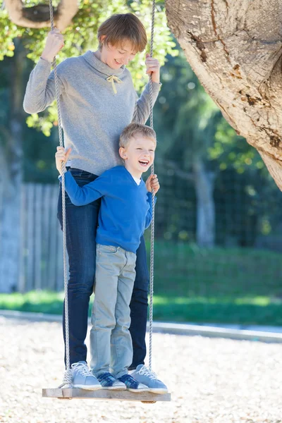 Family at swings — Stock Photo, Image